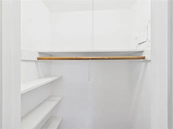 a view of a room with wooden floor and a ceiling fan