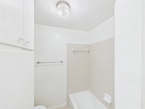 a bathroom with a shower and tub