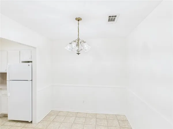 a view of a refrigerator in a white wall
