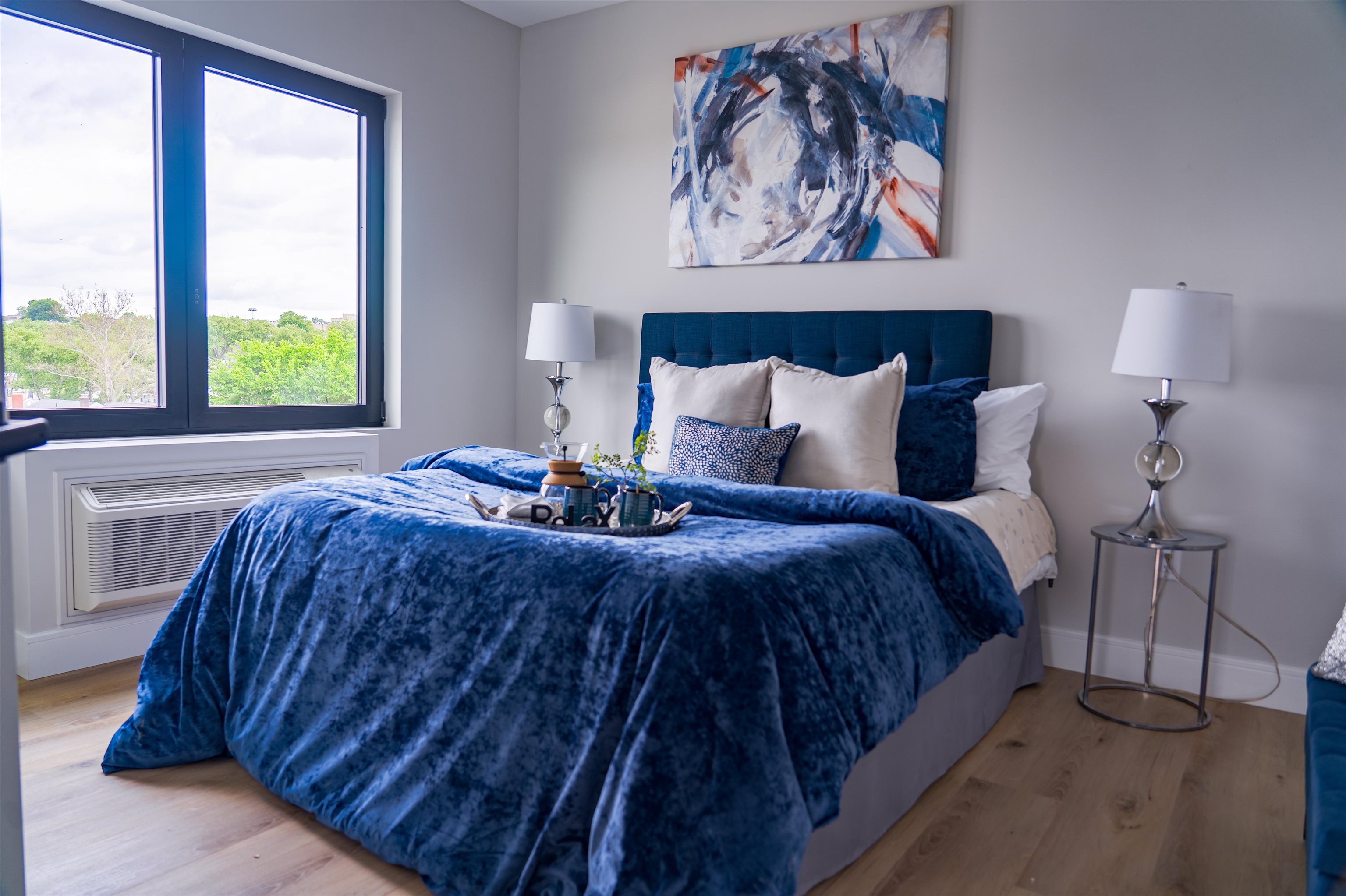 457 Schuyler Avenue, Unit 209 Kearny, NJ 07032 - Photo 22 of 37 a bedroom with a bed and a painting on the wall