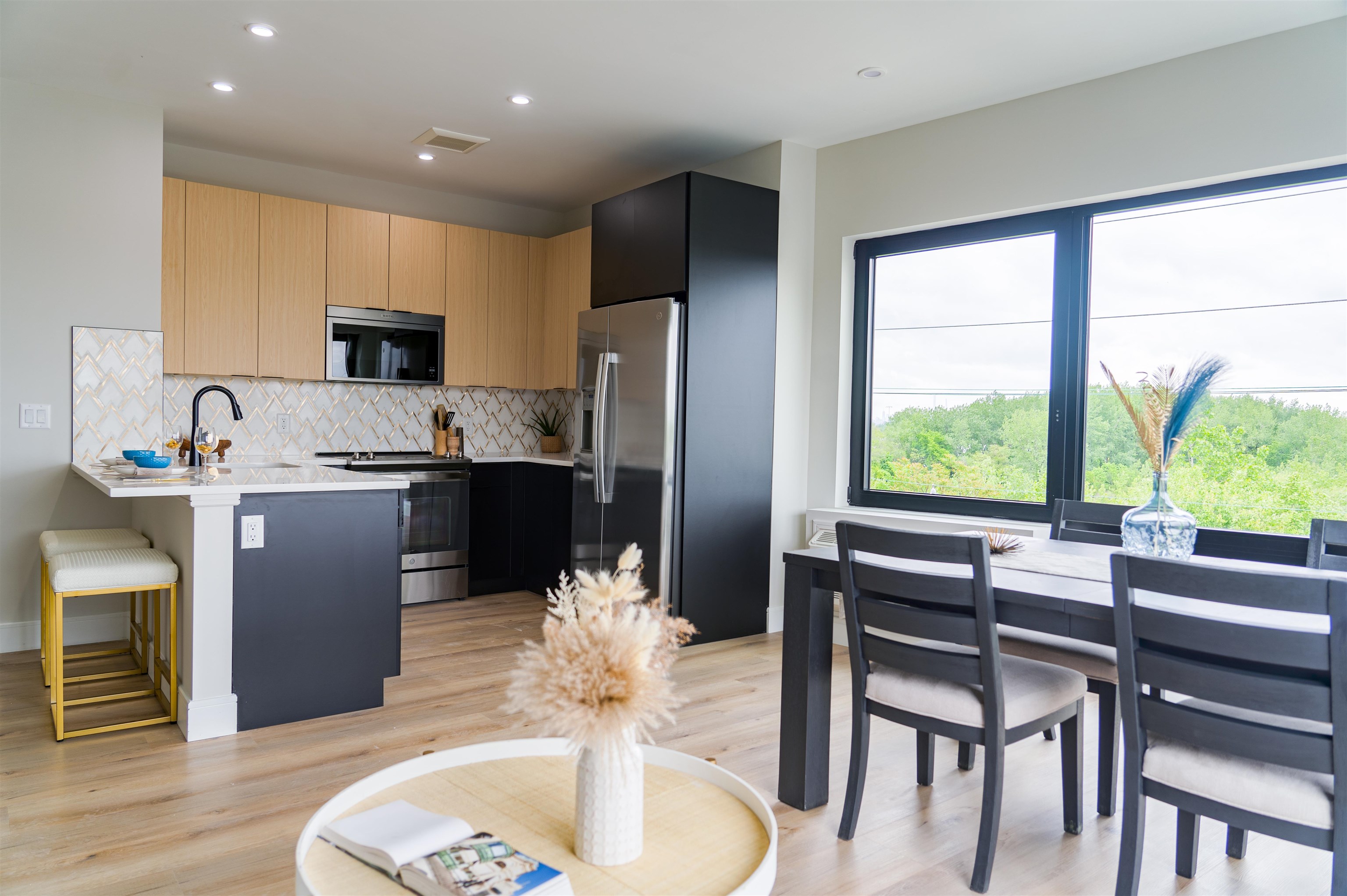 457 Schuyler Avenue, Unit 209 Kearny, NJ 07032 - Photo 10 of 37 a kitchen with a table chairs refrigerator and microwave