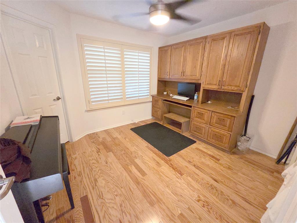 3908 Denham Way Plano, TX 75023 - Photo 19 of 23 a bedroom with a bed and wooden floor