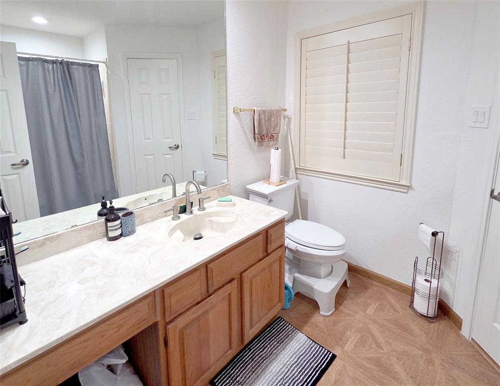 3908 Denham Way Plano, TX 75023 - Photo 21 of 23 a bathroom with a double vanity sink toilet and a mirror