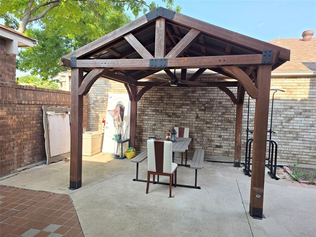 3908 Denham Way Plano, TX 75023 - Photo 5 of 23 a patio with table and chairs and potted plants