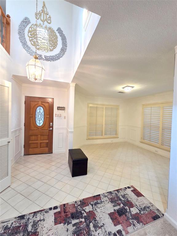 3908 Denham Way Plano, TX 75023 - Photo 7 of 23 a living room with a couch and a chandelier