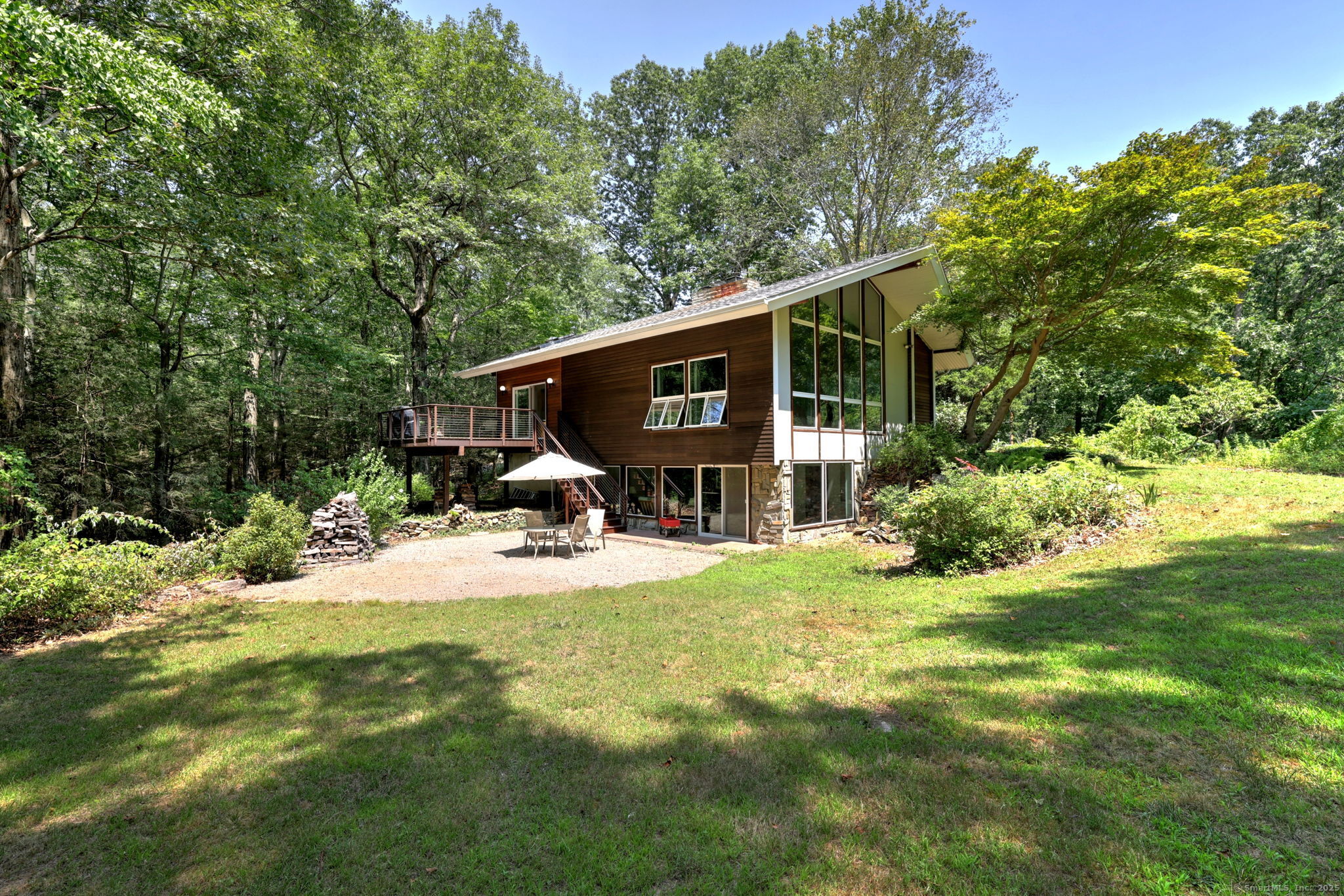 a front view of a house with yard and green space