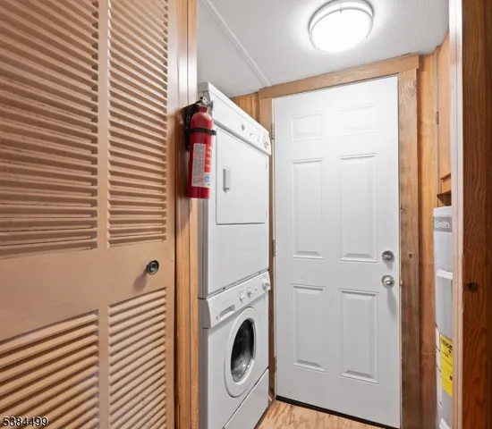 a view of a hallway with washer and dryer