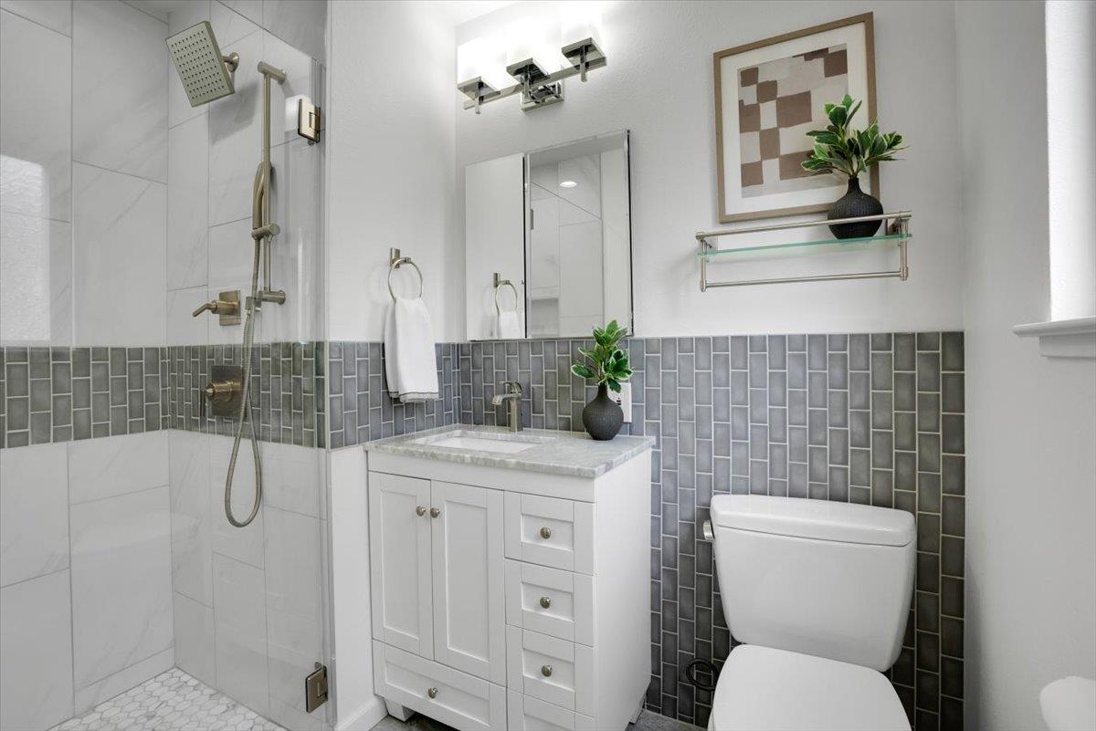 5459 Clovercrest Drive San Jose, CA 95118 - Photo 17 of 23 a bathroom with a granite countertop toilet sink and shower