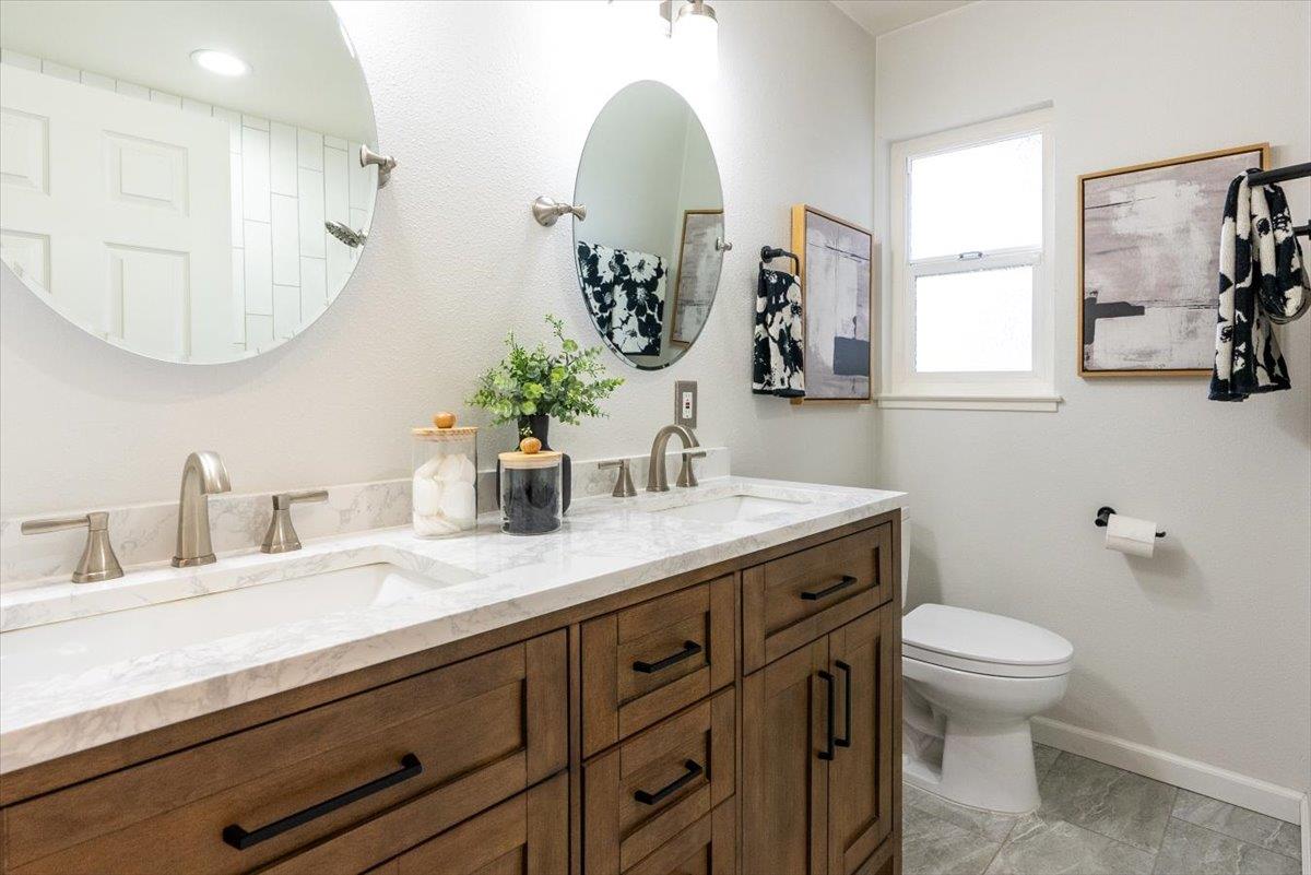 5459 Clovercrest Drive San Jose, CA 95118 - Photo 20 of 23 a bathroom with a granite countertop sink mirror and toilet