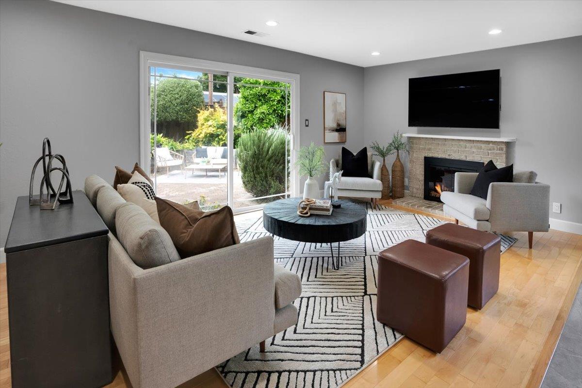 5459 Clovercrest Drive San Jose, CA 95118 - Photo 6 of 23 a living room with furniture a fireplace and a flat screen tv