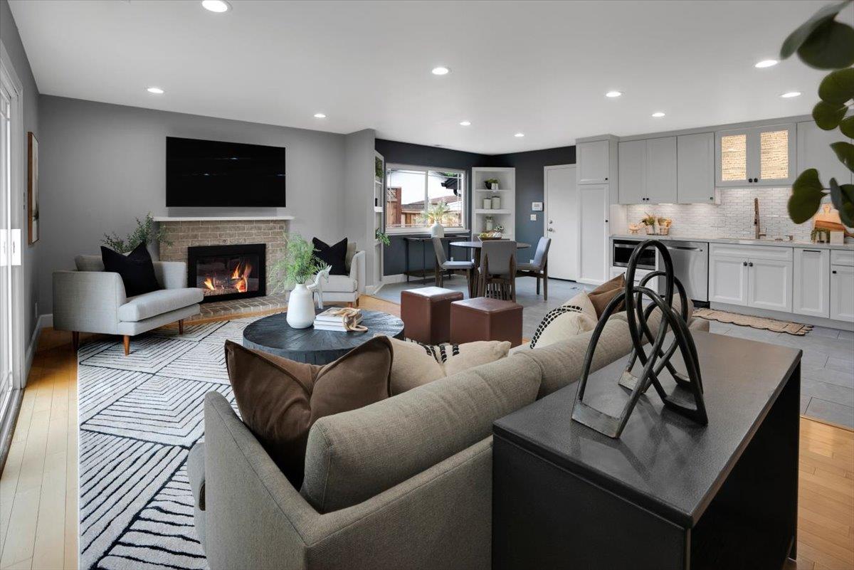 5459 Clovercrest Drive San Jose, CA 95118 - Photo 7 of 23 a living room with furniture a fireplace and a flat screen tv