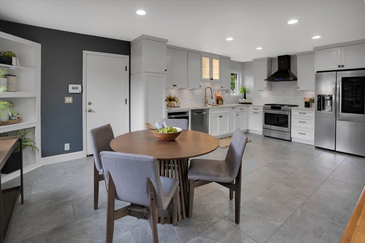 5459 Clovercrest Drive San Jose, CA 95118 - Photo 9 of 23 a kitchen with stainless steel appliances granite countertop a dining table chairs refrigerator and cabinets