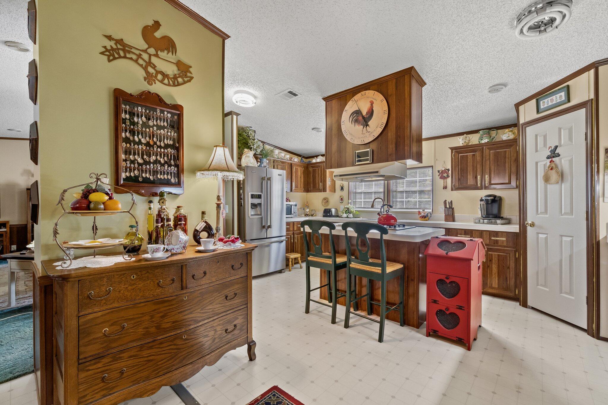 4281 Shell Landing Road Vernon, FL 32462 - Photo 17 of 55 a view of a kitchen with stainless steel appliances kitchen island granite countertop a stove a refrigerator and a dining table view