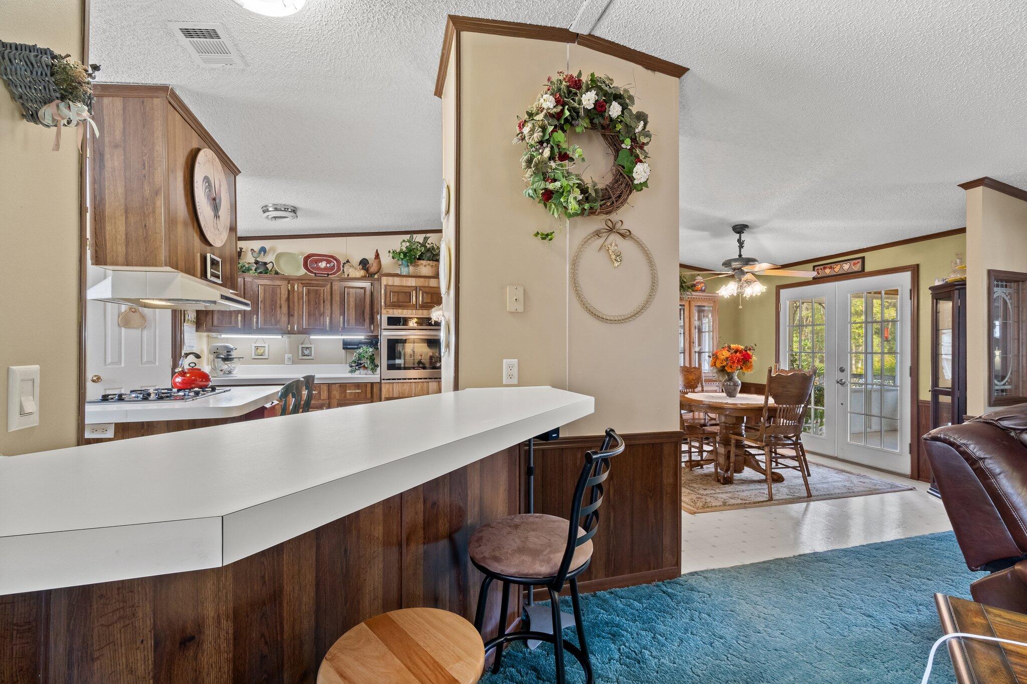 4281 Shell Landing Road Vernon, FL 32462 - Photo 20 of 55 a room with stainless steel appliances kitchen island a table and chairs in it
