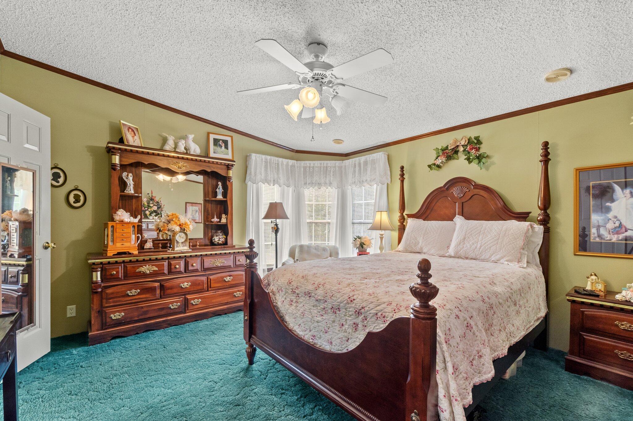 4281 Shell Landing Road Vernon, FL 32462 - Photo 21 of 55 a bedroom with a bed and a chandelier