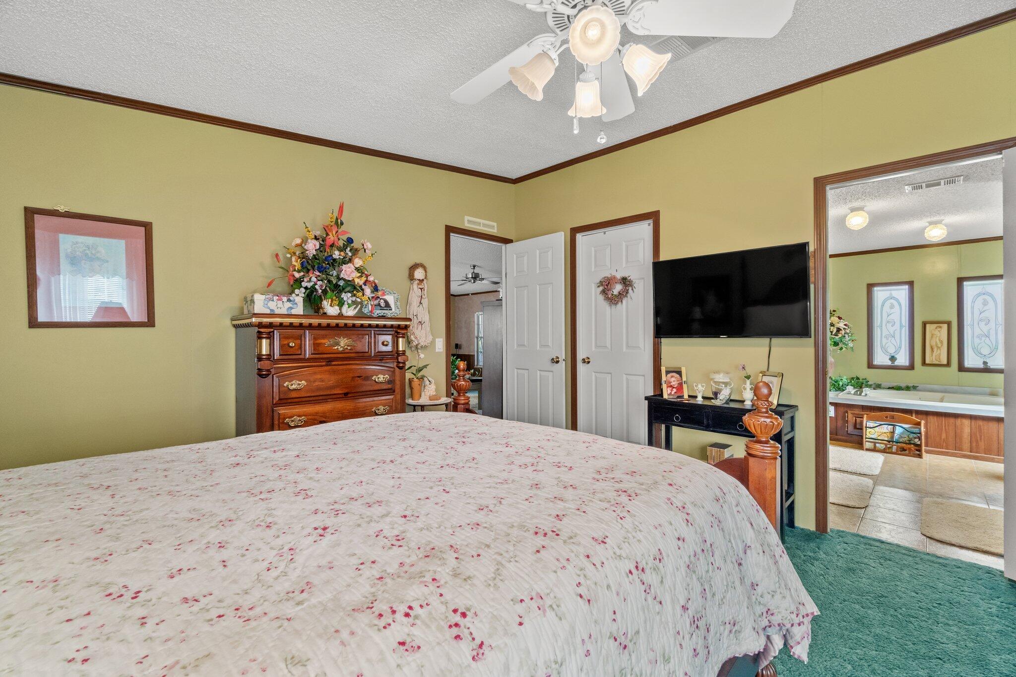 4281 Shell Landing Road Vernon, FL 32462 - Photo 22 of 55 a bedroom with a bed and a flat screen tv