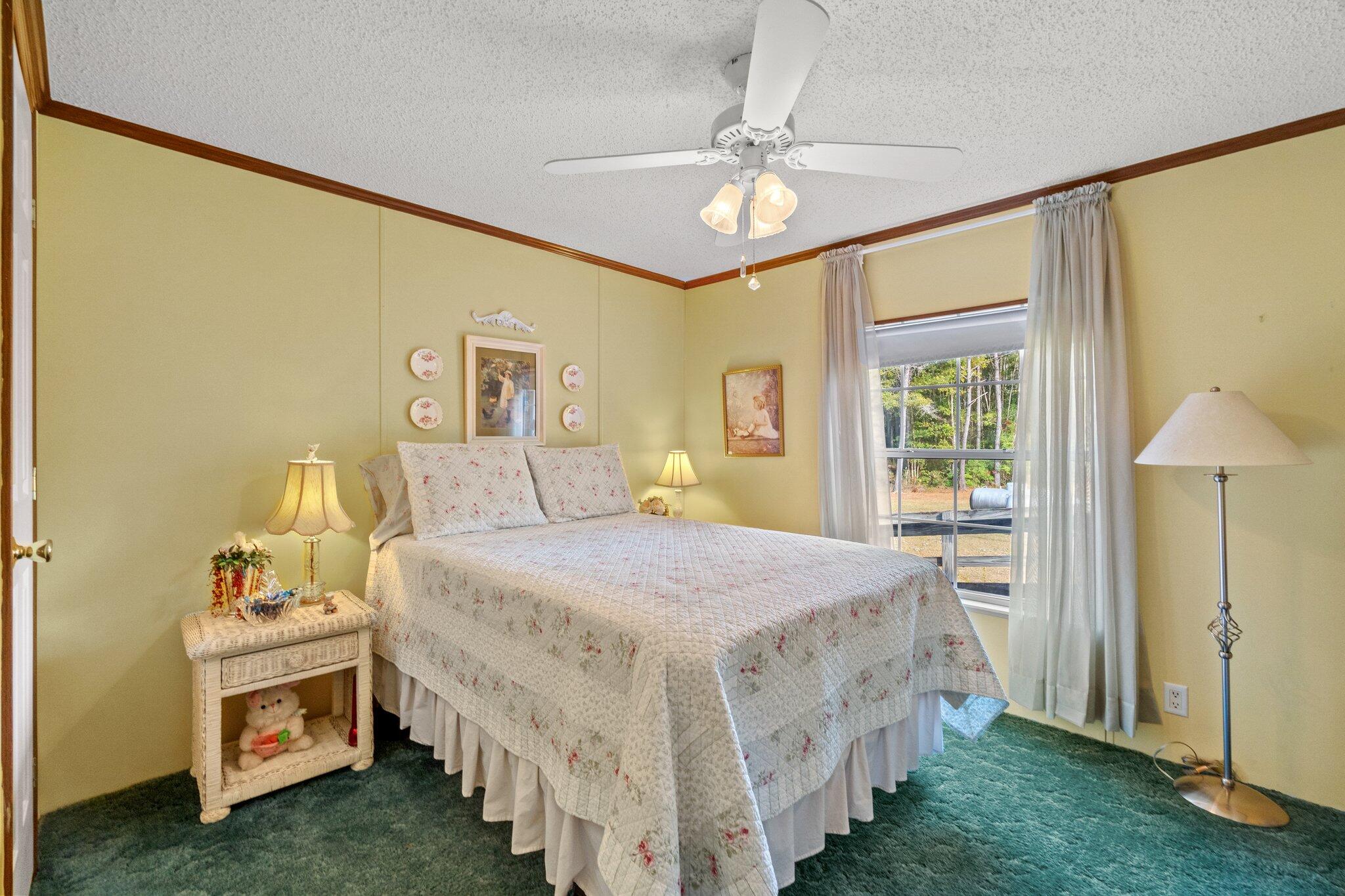 4281 Shell Landing Road Vernon, FL 32462 - Photo 26 of 55 a bedroom with a bed and a chandelier