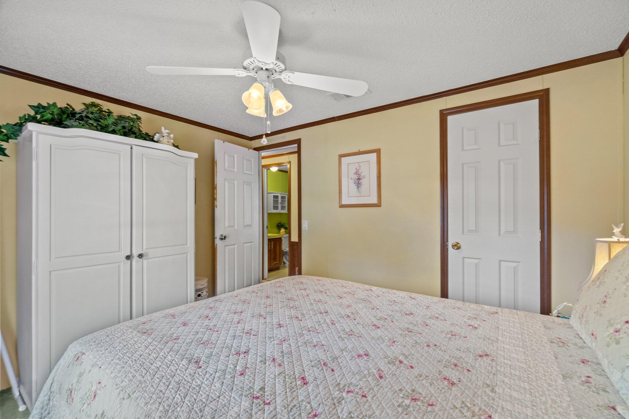 4281 Shell Landing Road Vernon, FL 32462 - Photo 27 of 55 a bedroom with a bed and a chandelier