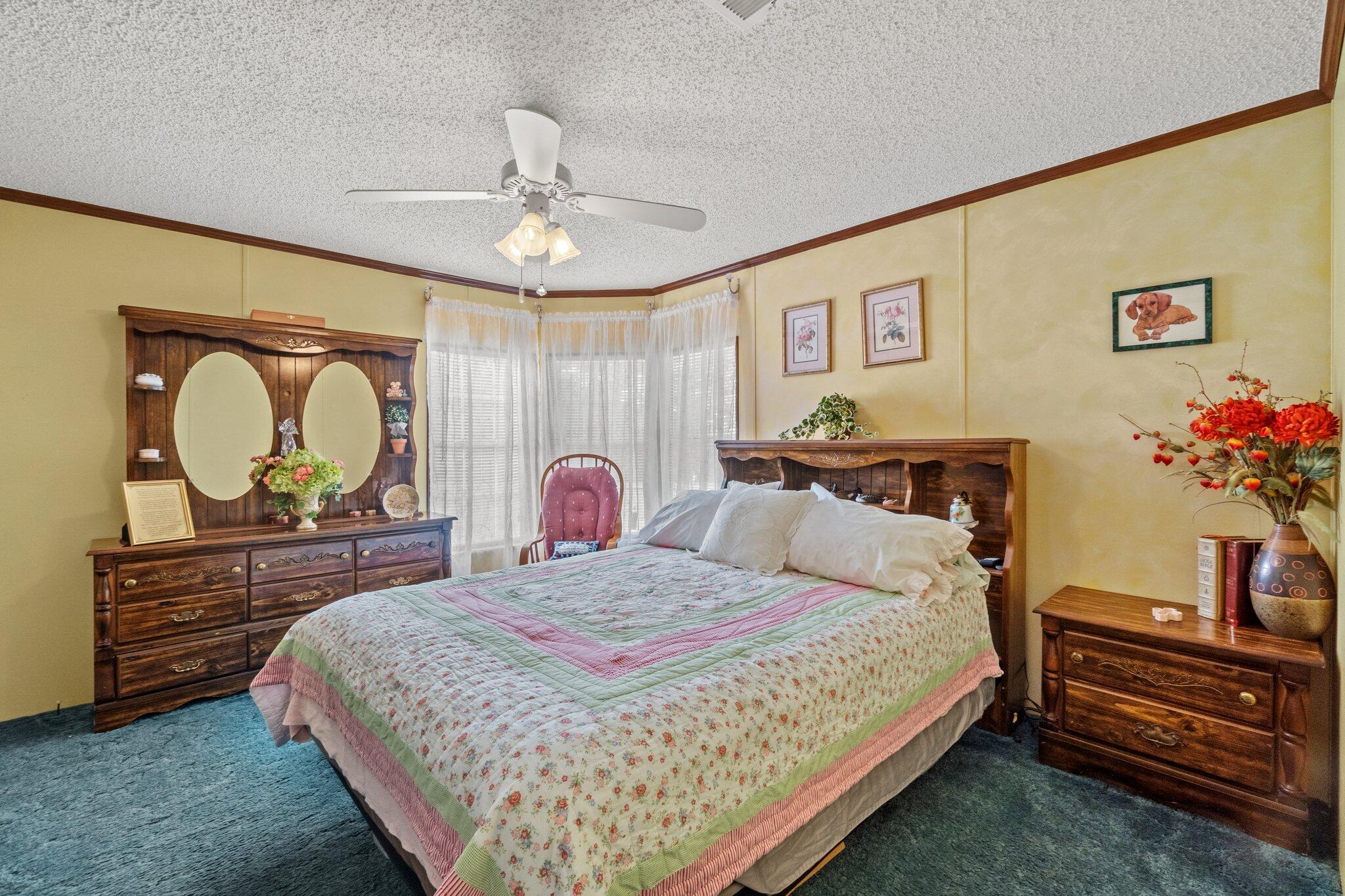 4281 Shell Landing Road Vernon, FL 32462 - Photo 29 of 55 a bedroom with a bed and dresser with mirror