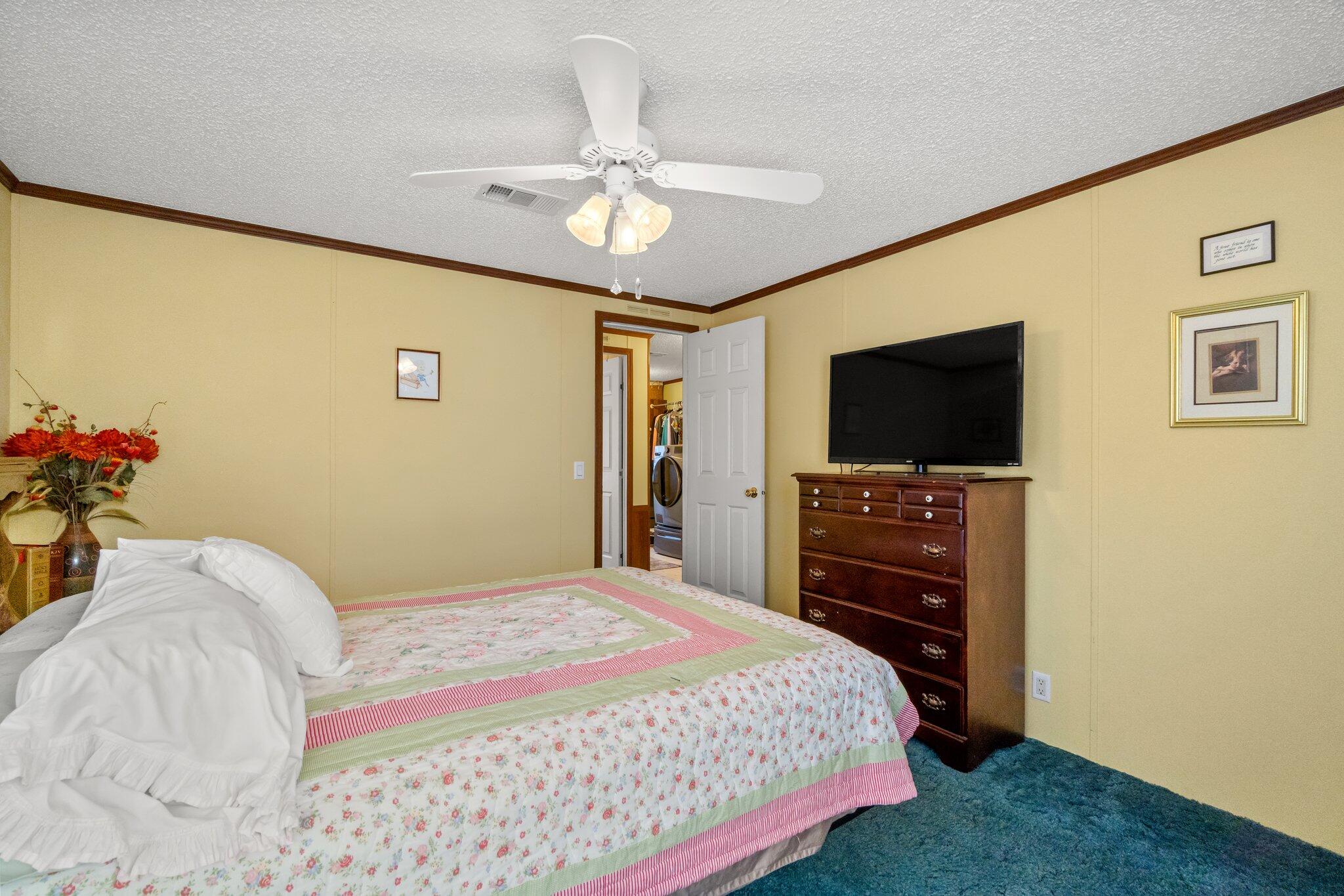 4281 Shell Landing Road Vernon, FL 32462 - Photo 30 of 55 a bedroom with a bed and a flat screen tv
