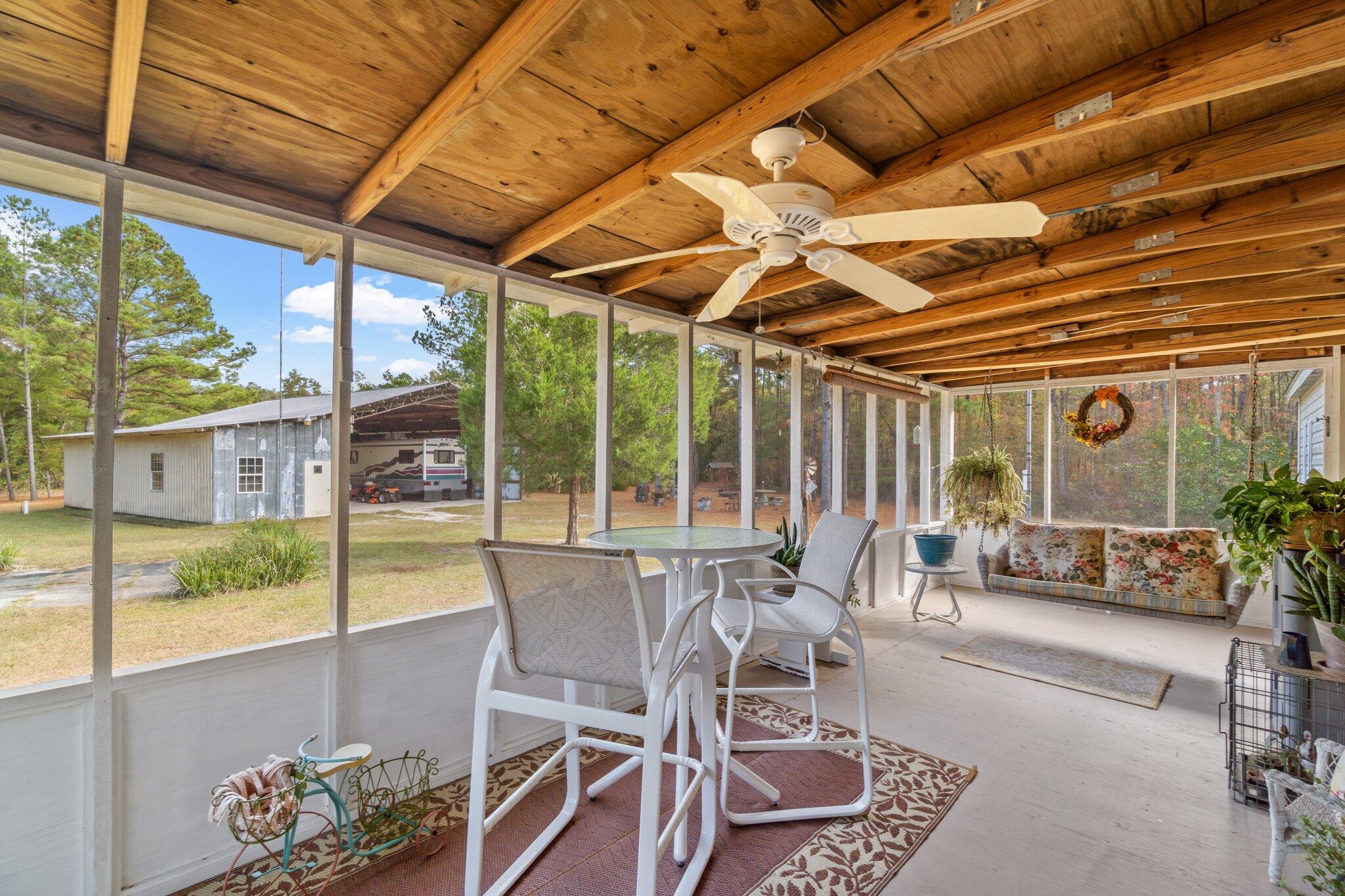 4281 Shell Landing Road Vernon, FL 32462 - Photo 32 of 55 a view of a patio with table and chairs and potted plants