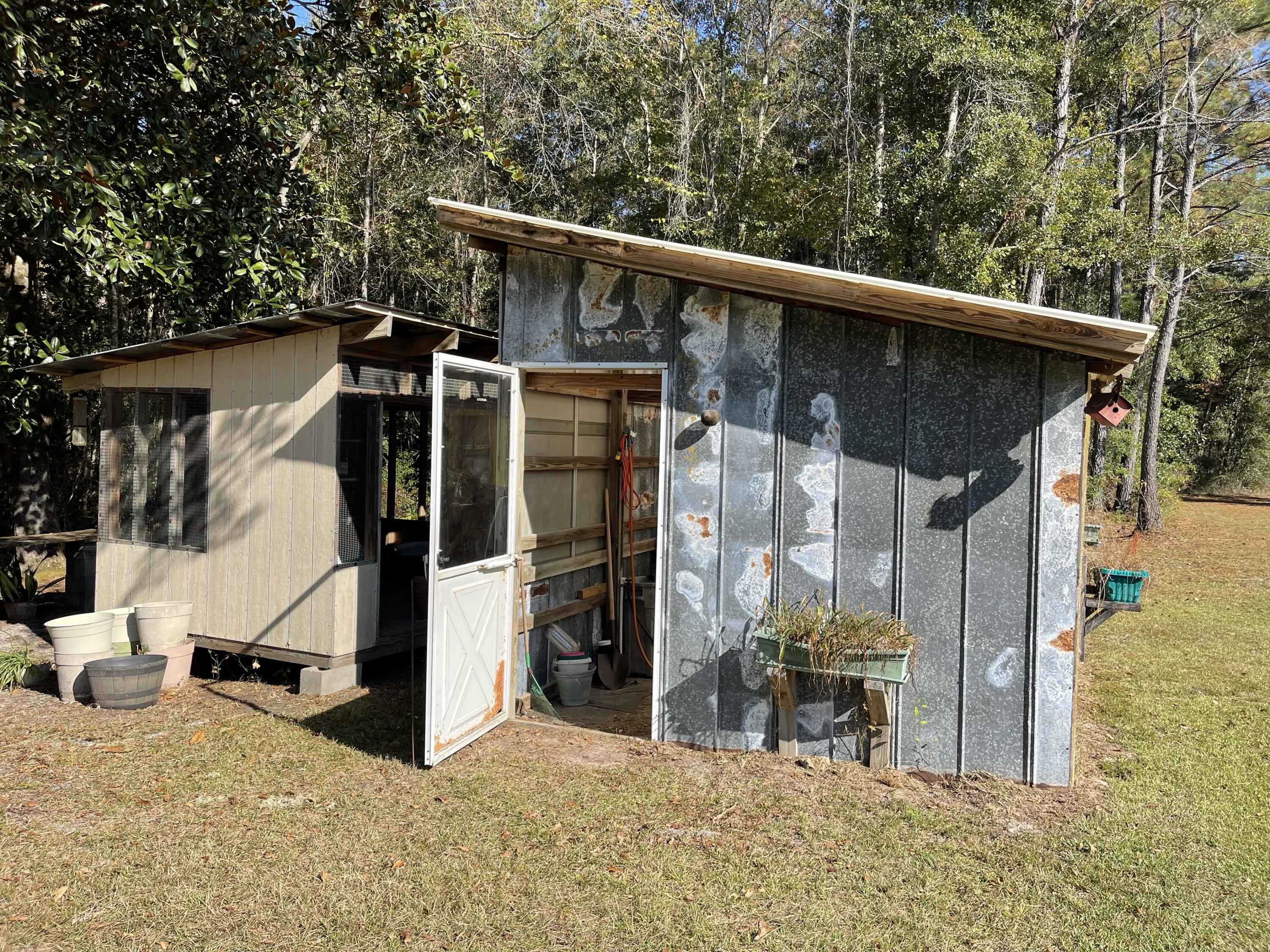 4281 Shell Landing Road Vernon, FL 32462 - Photo 38 of 55 a view of a wooden house with a large tree