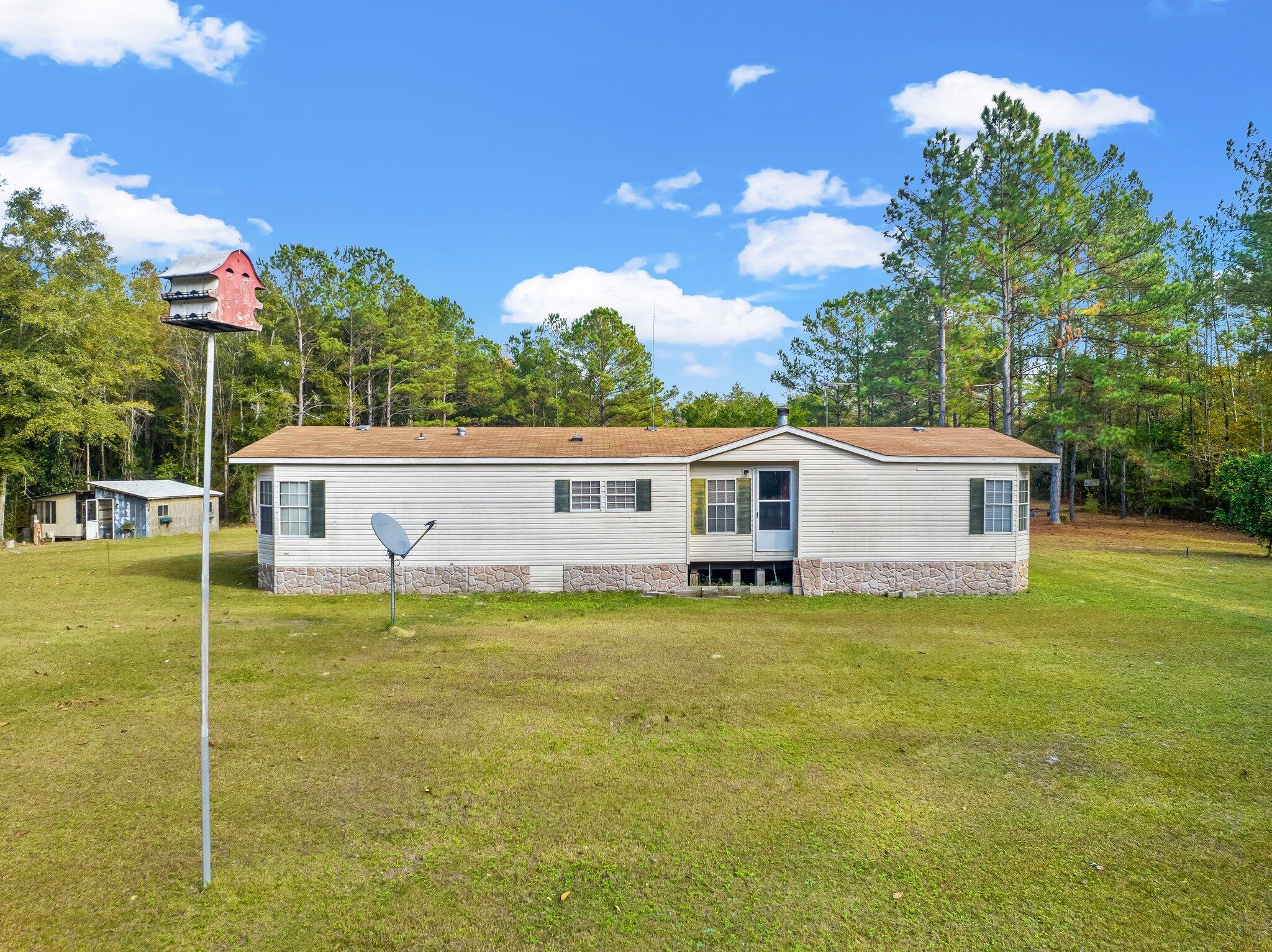4281 Shell Landing Road Vernon, FL 32462 - Photo 45 of 55 a front view of a house with a yard