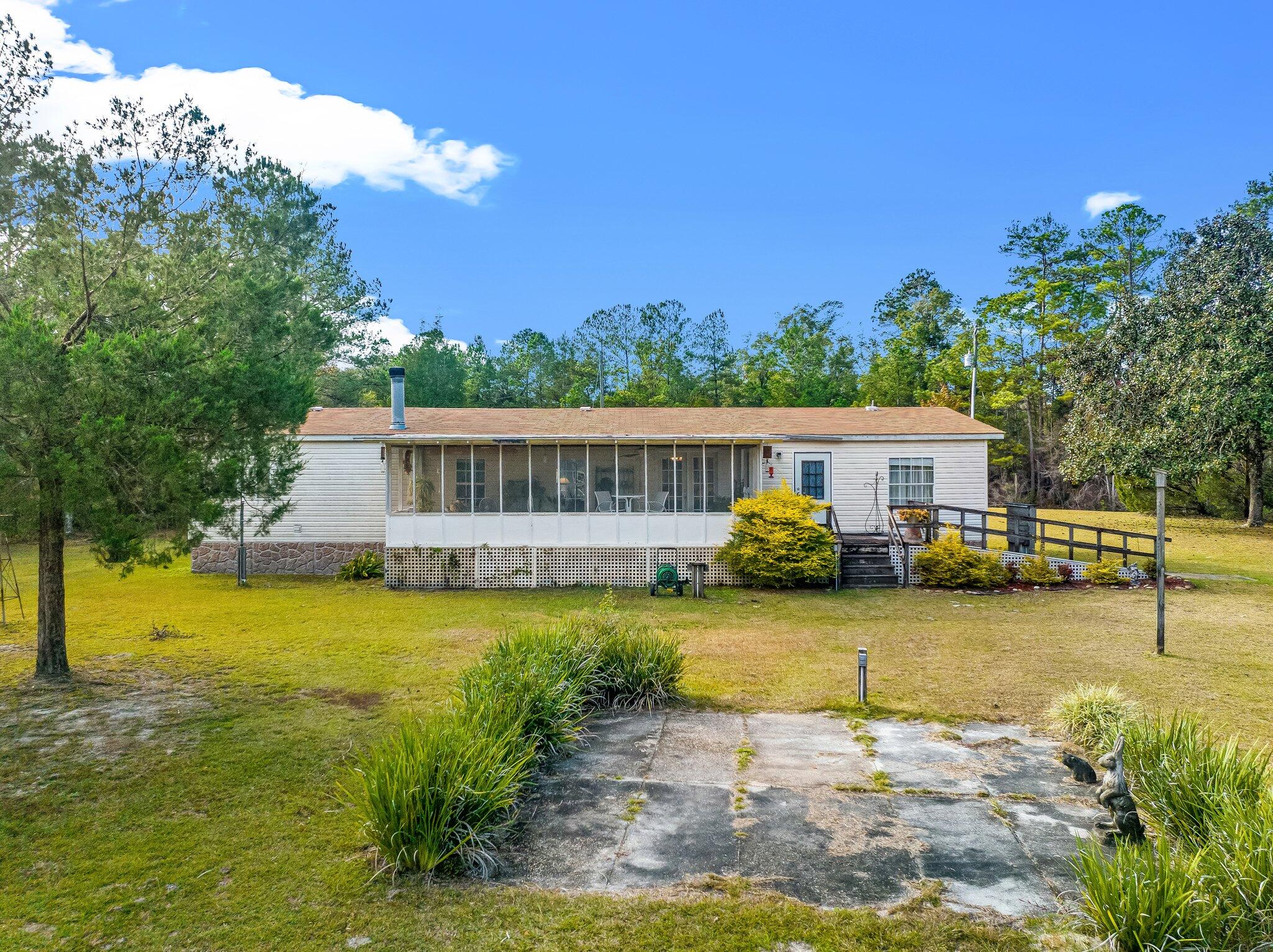 4281 Shell Landing Road Vernon, FL 32462 - Photo 47 of 55 a front view of a house with garden