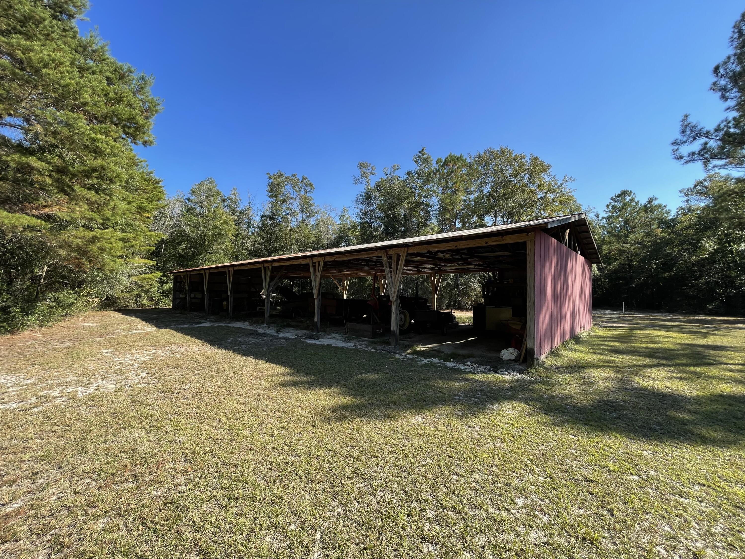 4281 Shell Landing Road Vernon, FL 32462 - Photo 9 of 55 a view of a barn in the middle of a yard