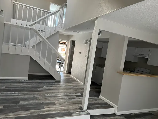 a view of entryway and hall with wooden floor