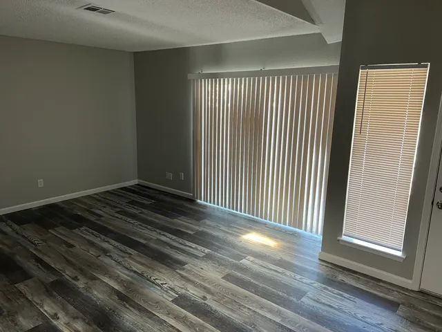 a view of a room with wooden floor