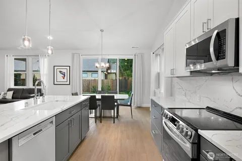 a bathroom with a granite countertop sink toilet and a mirror