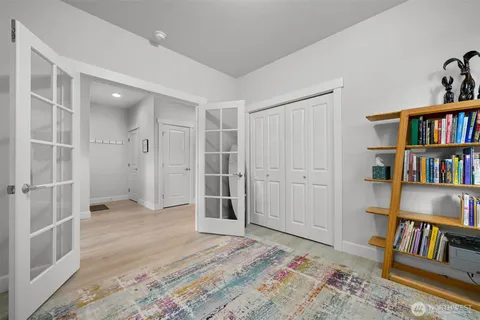 a front view of a house with a garden and garage