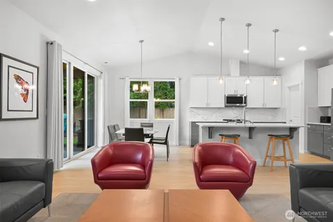 a kitchen with stainless steel appliances granite countertop a stove a sink a refrigerator and a microwave