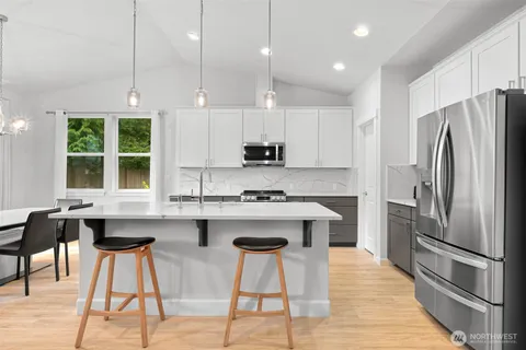 a large kitchen with stainless steel appliances kitchen island a large island in the center