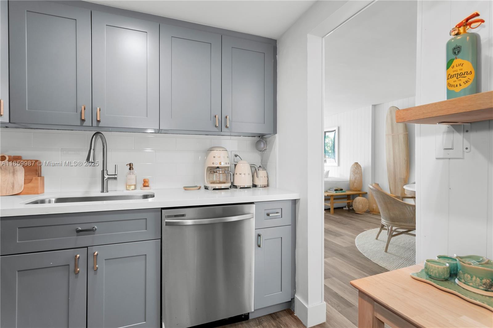 4301 Collins Avenue, Unit 207 Miami Beach, FL 33140 - Photo 11 of 34 a kitchen with a sink and cabinets