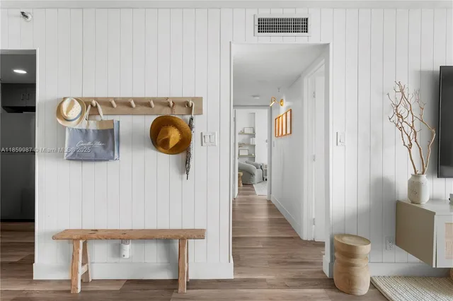 a view of entryway and hall with wooden floor