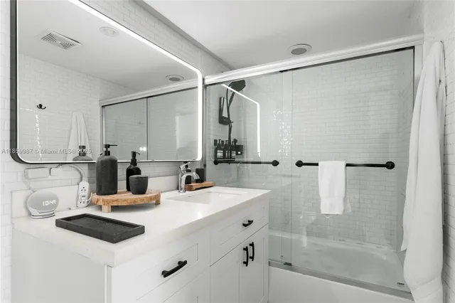 a bathroom with a double vanity sink mirror and shower