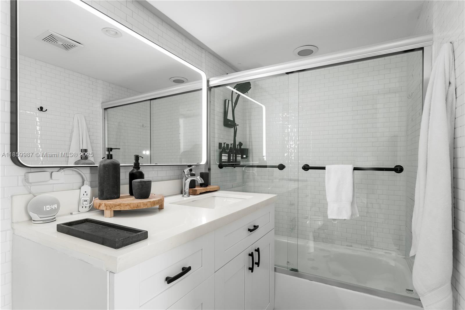 4301 Collins Avenue, Unit 207 Miami Beach, FL 33140 - Photo 20 of 34 a bathroom with a double vanity sink mirror and shower