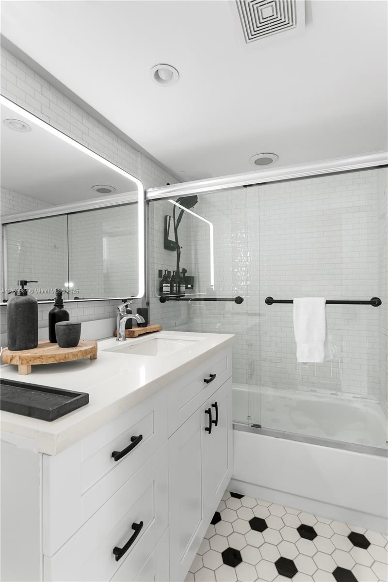 4301 Collins Avenue, Unit 207 Miami Beach, FL 33140 - Photo 21 of 34 a bathroom with a tub sink and mirror