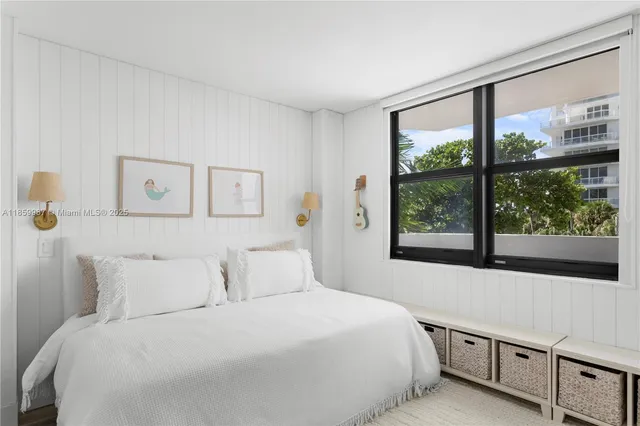 a bedroom with a large bed and a large window