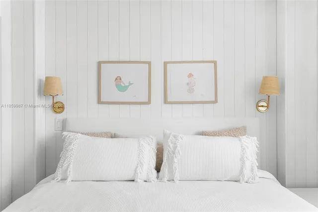 a white couch sitting next to a white wall