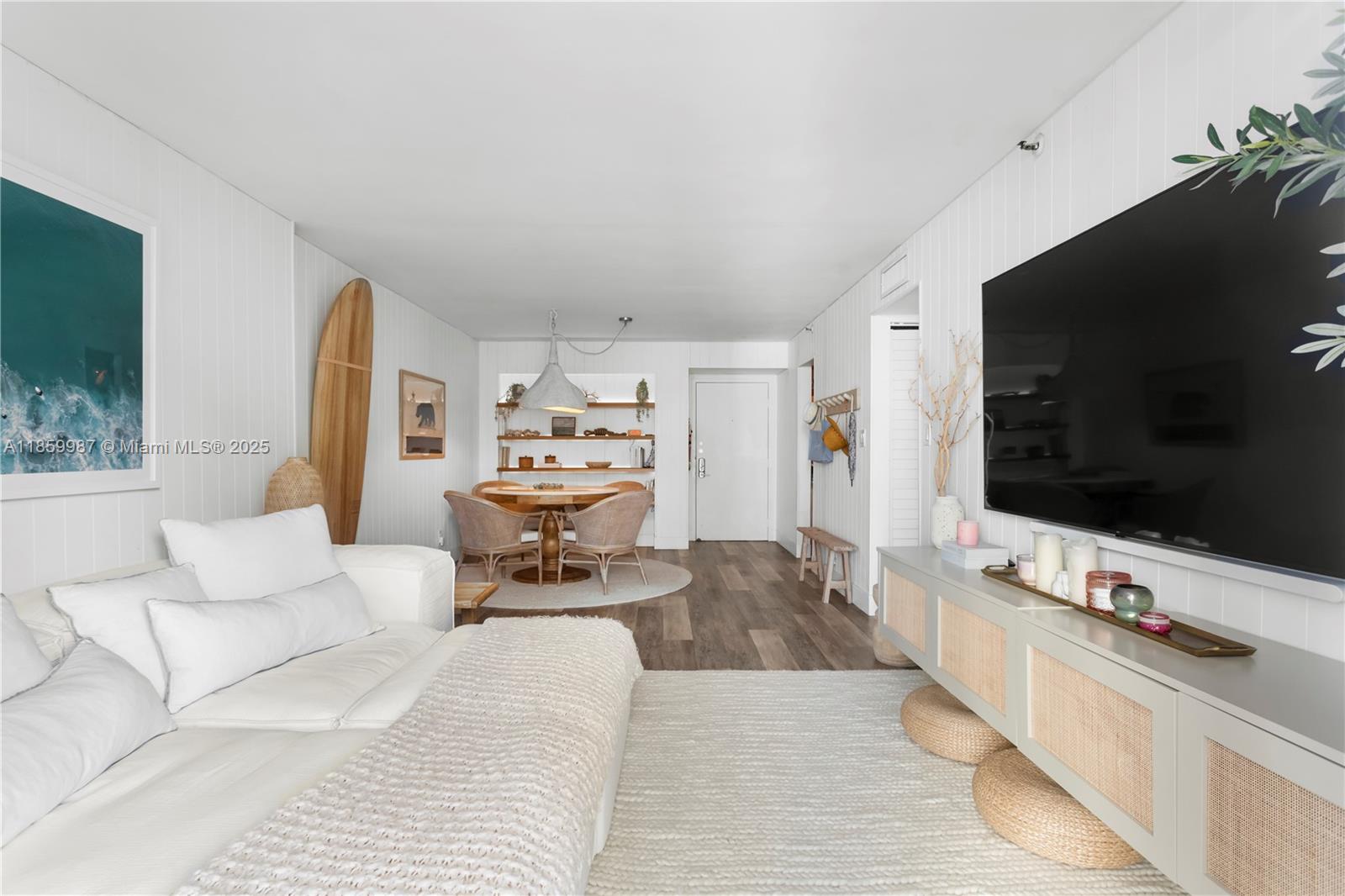 4301 Collins Avenue, Unit 207 Miami Beach, FL 33140 - Photo 4 of 34 a living room with furniture and a flat screen tv