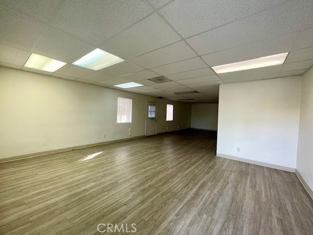 2176 West Foothill Boulevard, Unit C Upland, CA 91786 - Photo 1 of 8 an empty room with wooden floor and windows