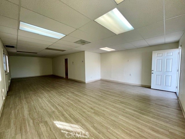 2176 West Foothill Boulevard, Unit C Upland, CA 91786 - Photo 2 of 8 an empty room with wooden floor and windows