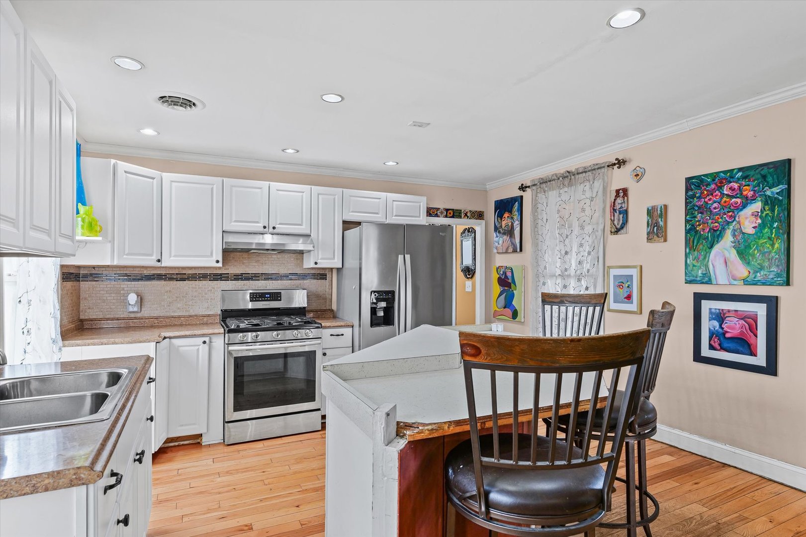2210 Fogel Road Mahomet, IL 61853 - Photo 11 of 33 a kitchen with stainless steel appliances granite countertop a stove a refrigerator a kitchen island a dining table and chairs with wooden floor
