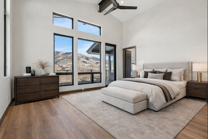 1325 Golden Eagle Road Silverthorne, CO 80498 - Photo 5 of 46 a spacious bedroom with a large bed and a large window