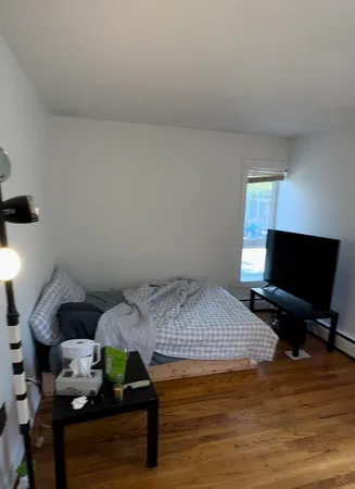 a bedroom with a bed and a tv