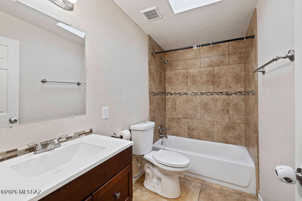 1301 West Kleindale Road Tucson, AZ 85705 - Photo 15 of 27 a bathroom with a sink a toilet and shower