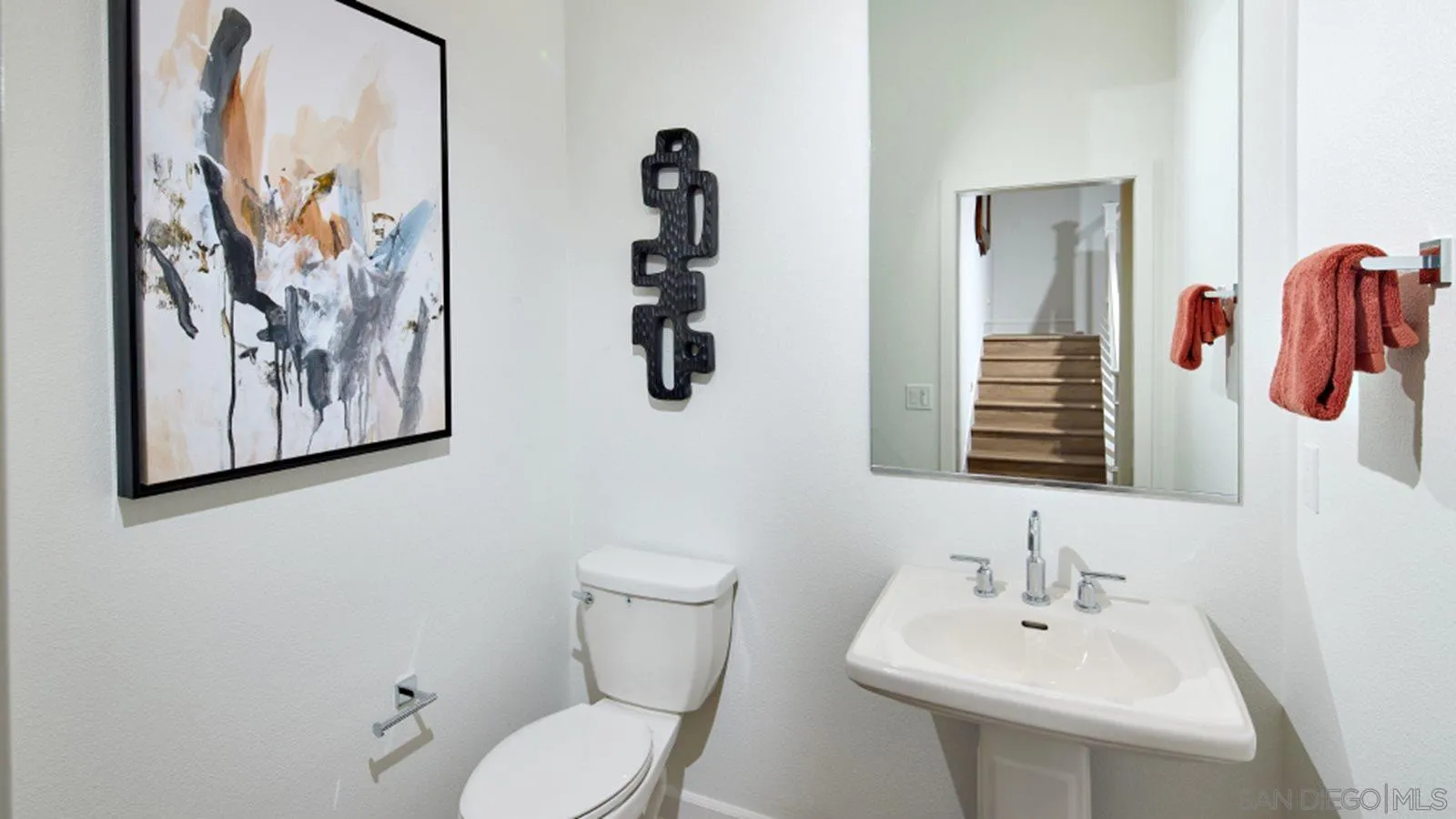 15366 Junipers Drive San Diego, CA 92129 - Photo 17 of 19 a bathroom with a toilet sink and mirror